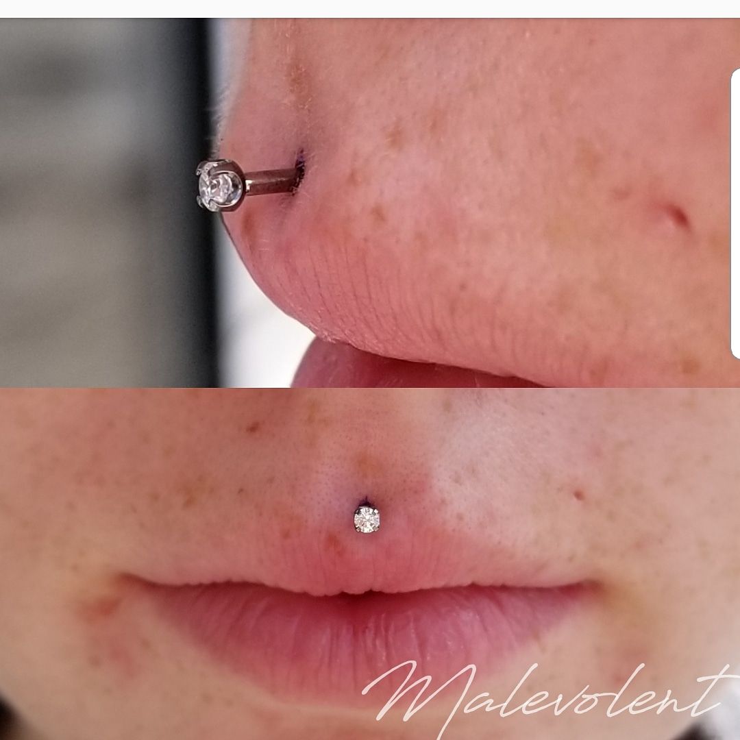 philtrum piercing sitting on the centre line above the upper lip